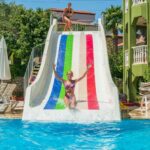 a woman on a water slide in a pool